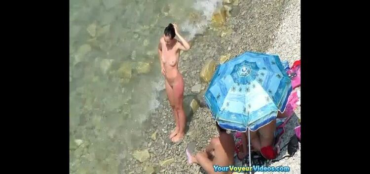 Nude women in rocky beach