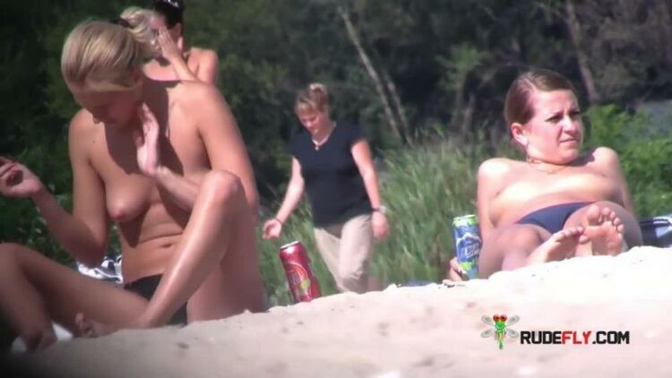 Young nudist friends naked together at the beach 2