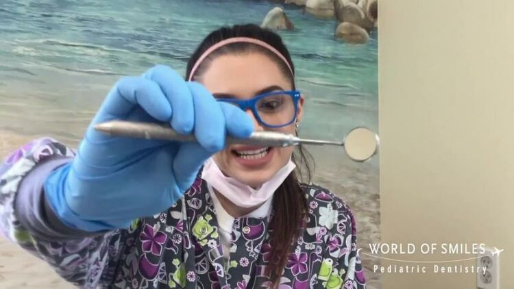 Hot dental assistant puts on gloves and mask