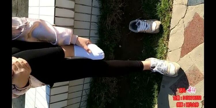 Chinese girl sprains foot in black leggings and white ankle socks