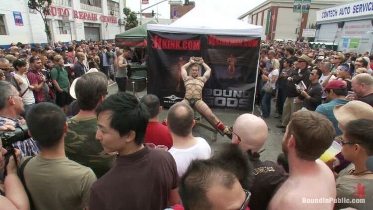 Muscle slave is stripped naked, used and humiliated while hordes of people take photos.